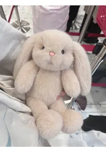 Close up view of the cute lop-eared bunny plush toy with soft fur and pink nose in store.