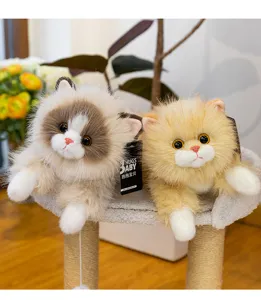 Close-up detail of cute plush cat dolls resting on a cozy cat tree with soft fabric.