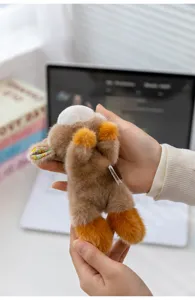 Detailed view of cute brown plush animal toy with floral ears and soft furry texture for gift.