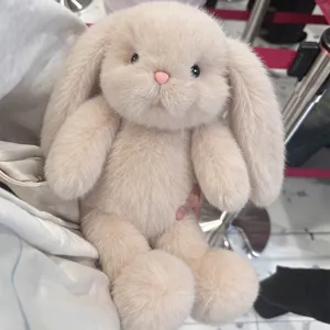 Cute beige lop-eared bunny plush toy, soft long-haired stuffed rabbit doll for hugging.