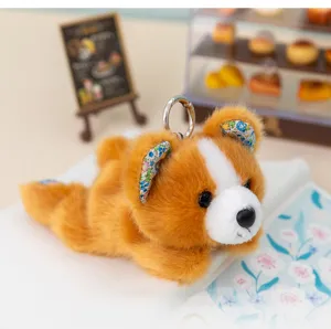 Detailed close-up shot of cute floral plush lying animal toy keychain in a miniature bakery.