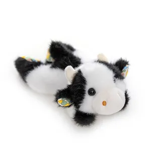 Cute black and white cow plush toy with floral ears, soft lying animal doll for kids gift.