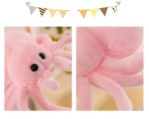 Close-up detail of the cute pink spider plush toy, soft fuzzy texture and shiny big eyes.