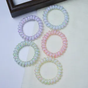 Detailed shot of colorful polka dot telephone wire hair ties, high elasticity spiral hair bands.