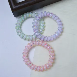 Detail of colorful polka dot telephone wire hair ties, high elasticity and seamless design.