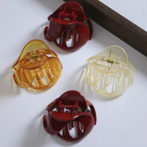 Close-up detail shot of irregular resin hair claws, multi-color stylish shark clips for half up.