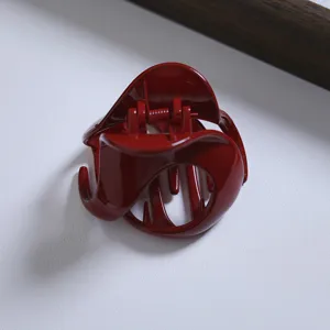 Wine red irregular hair claw clip detail, elegant half-up hairstyle accessory, medium size.