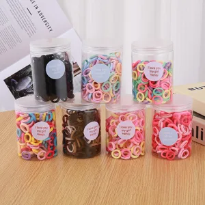 Detailed view of colorful hair ties in clear jars, cute candy colors for kids daily styling.
