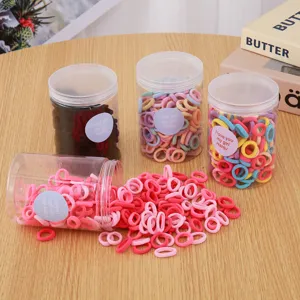 Colorful elastic hair bands for kids, small seamless hair ties in transparent storage jars.