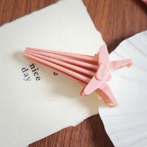 Pink plastic bangs hair clip for root volume and daily styling, portable hair accessory.