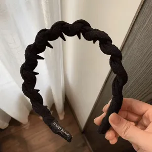 Black twisted hair hoop with inner teeth, fabric wrapped headband for stylish daily hair styling.