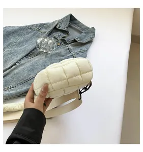 White quilted cloud crossbody bag for women, lightweight nylon puffer chest bag with wide strap.