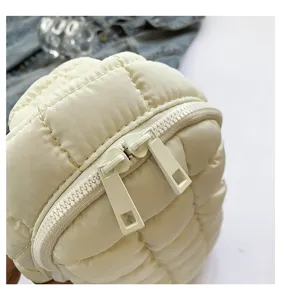 Detailed close-up view showcasing the dual metal zippers and soft quilted fabric texture.