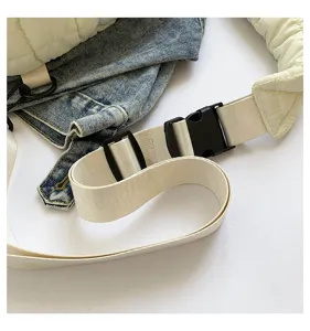 Detail view of the lightweight quilted cloud chest bag strap, adjustable buckle and denim.