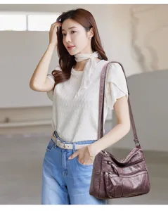 Detailed shot of multi-pocket washed soft leather shoulder bag showing daily wear scene.