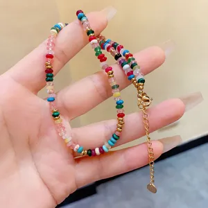 Close-up of bohemian colorful stone beaded necklace with gold extender chain