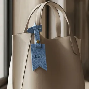 Personalized PU leather letter bag charm detail view showing custom alphabet pendant on bag.