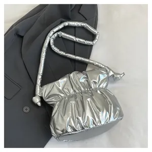 Silver metallic puffer shoulder bag detail, stylish pleated nylon crossbody bucket bag for women.