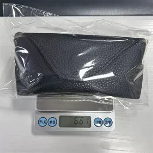 Detail view of black PU leather folding glasses pouch, portable protective sunglasses case.
