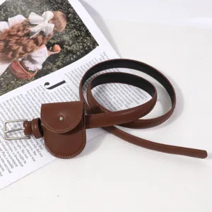 Detailed shot of brown leather waist belt with mini pouch accessory on vintage magazine backdrop.