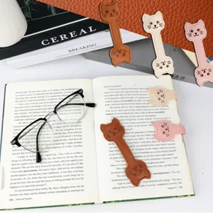 Close-up detail of cute cat leather magnetic bookmarks, perfect for reading and book lovers.