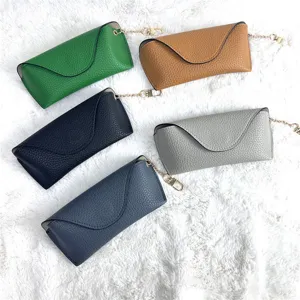 Detail view of minimalist leather glasses case with chain strap, portable and anti-pressure.