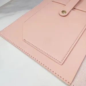 Pink PU leather notebook folder detail close up, showing fine stitching and snap button.