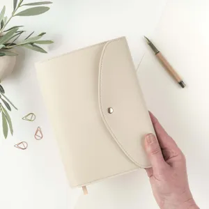 Detailed view of the elegant beige PU leather A5 notebook folder with snap button closure.