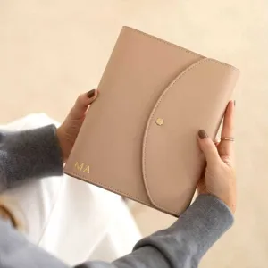 PU leather A5 notebook folder three-fold organizer with custom snap closure and initials.