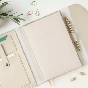 Detailed view of beige PU leather trifold A5 notebook organizer with elegant flat lay.