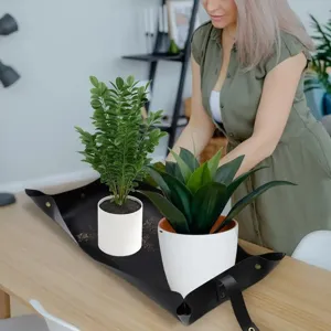 Waterproof thick leather gardening mat for indoor plants, repotting tray and dirt resistant pad.