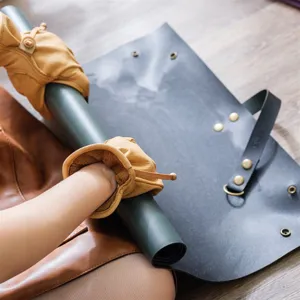 Waterproof thickened leather gardening mat for indoor plant repotting and soil changing.