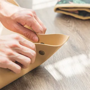 Waterproof thickened leather gardening mat detail showing snap button and durable material.