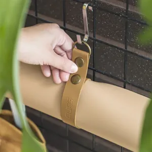 Leather gardening mat detail view, thickened waterproof material, convenient hanging strap storage.