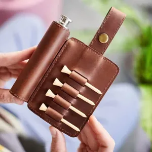 Etui en cuir pour tees de golf et flasque avec tees en bois, vue de detail raffinee et elegante.