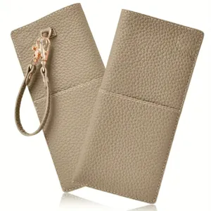 Close-up detail of taupe leather glasses pouch with wrist strap and gold metal clasp.