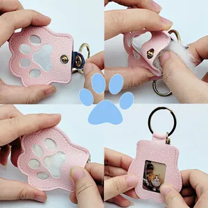 Detailed view demonstrating how to use the pink cat paw pet hair storage keychain pendant.