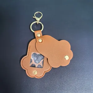 Cute paw shaped leather keychain with clear window and gold metal hardware for pet photos.