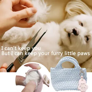 Pet memorial keychain detail showcasing the portable dog paw keepsake pouch for pet hair storage.