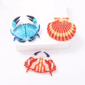 Close-up details of marine acrylic crab and seashell charms, vibrant colors, smooth glossy finish.