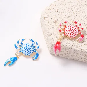 Close-up detail of cute crab brooch, sweet alloy printed design, summer beach vacation accessory.