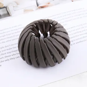 Dark grey bird's nest hair clip, expandable bun maker and ponytail holder for women styling.