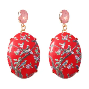 Close-up detail van Chinese traditionele bloem vogel oorbellen met roze kristal.
