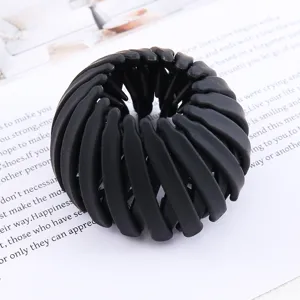 Close-up of a black expandable bird's nest hair clip, perfect for stylish lazy ponytails.