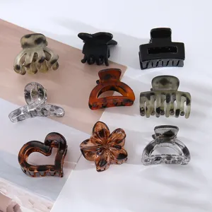 Detailed view of assorted small hair claws featuring floral and geometric designs in tortoise shell.