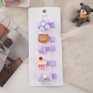 Cute purple hair clips detail shot, sweet cartoon bear and flower design for little girls.