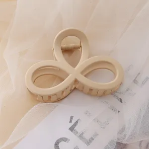 Elegant minimalist beige acrylic hair claw clip, chic daily hair accessory for women styling.