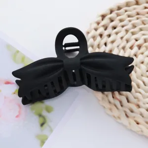 Black matte bow hair claw detail, solid acrylic shark clip for stylish daily hair styling.