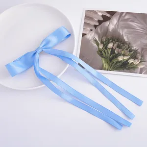 Light blue satin ribbon bow hair clip with long tails, sweet ballet style hair accessory.