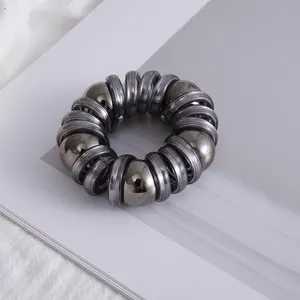 Elastico per capelli a spirale metallica con perle lucide, accessorio elegante per coda.